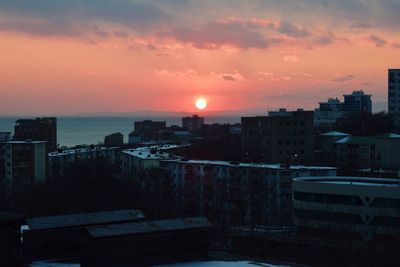 High angle view of buildings against romantic sky at sunset