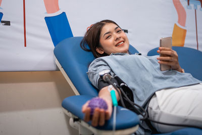 Portrait of young woman using mobile phone