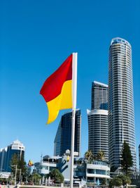 Low angle view of modern buildings against blue sky