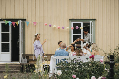 Male and female friends celebrating during dinner party at cafe