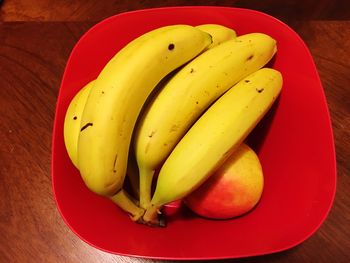 Bananas in a red bowl