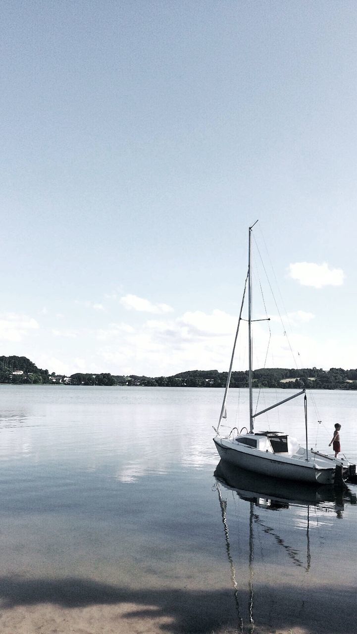 BOATS MOORED AT SEA AGAINST SKY