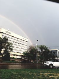 Street by buildings in city against sky