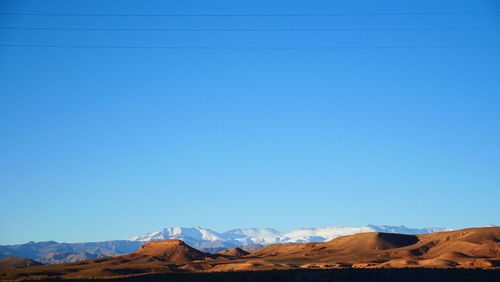 Scenic view of mountain against blue sky