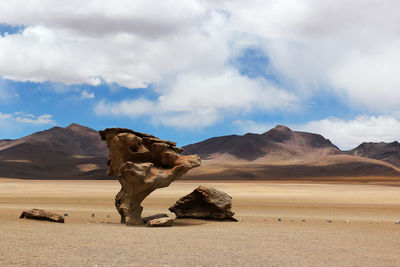 Rock formation at desert against sky