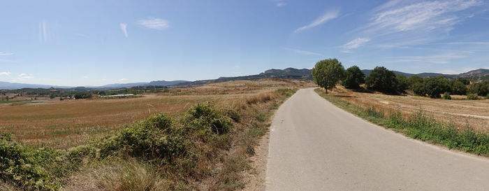 Empty road along countryside landscape