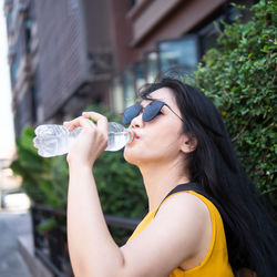 Young man drinking water from bottle