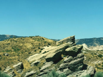 Scenic view of rocky mountains against clear blue sky