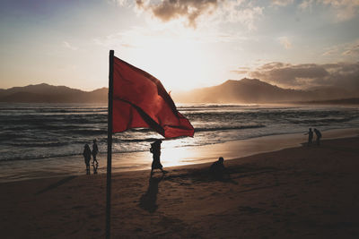 Scenic view of beach against sky during sunset