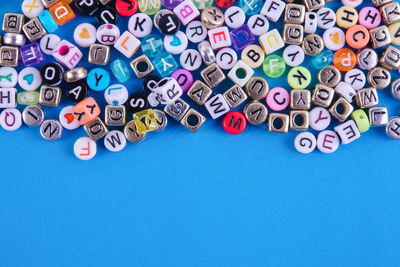 Directly above shot of blocks with alphabets on blue background