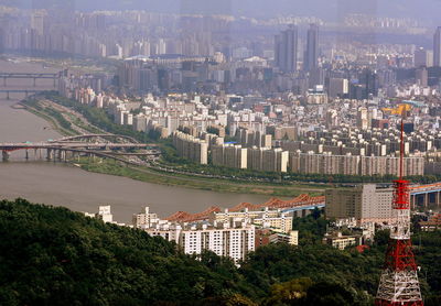 High angle view of buildings and trees in city