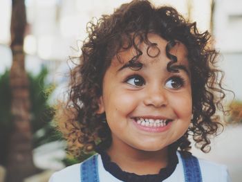 Close-up of cute smiling girl looking away