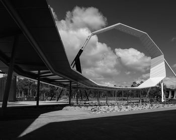 Low angle view of bridge against cloudy sky