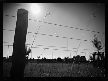 Barbed wire fence on field