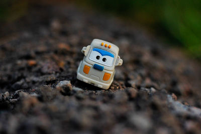 Close-up of toy car on rock