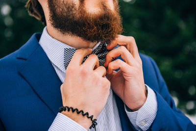 Midsection of man holding camera