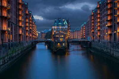 View of bridge over river at night