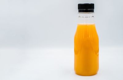 Close-up of yellow bottle against white background