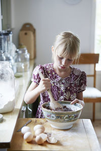 Girl mixing flour