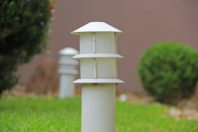 Close-up of lamp post on field