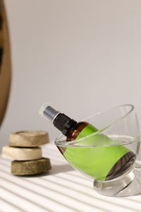 Close-up of bottle in glass on table