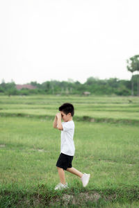 Full length of man running on field