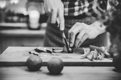 Midsection of person cutting vegetable