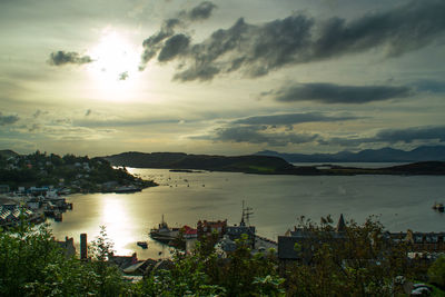 Scenic view of sea against cloudy sky during sunset