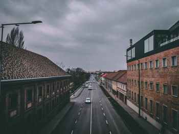 Street amidst buildings in city against sky