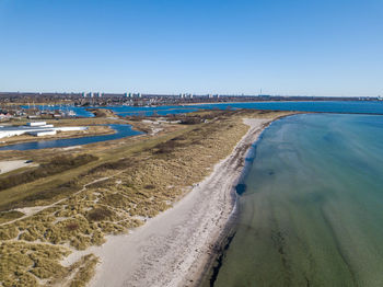 Scenic view of beach against clear blue sky