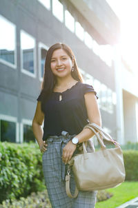 Portrait of smiling woman standing outdoors