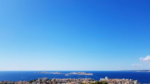 Scenic view of sea against clear blue sky