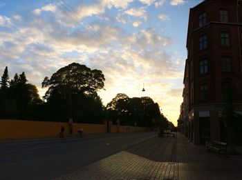 Empty road against cloudy sky