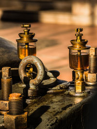 Close-up of oil container on machinery at industry