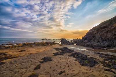 Scenic view of beach against sky during sunset