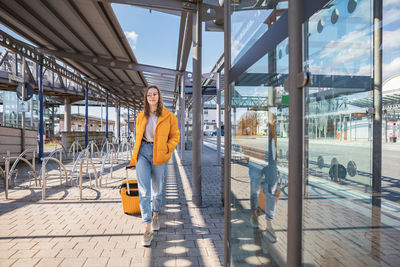 Portrait of woman standing on walkway