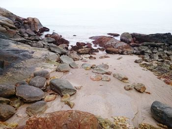 Rocks on beach against sky