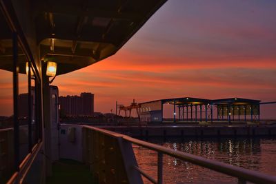 Bridge over river against sky during sunset