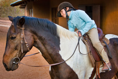 Midsection of man riding horse