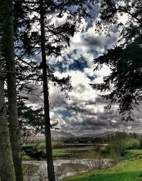 Scenic view of lake against cloudy sky