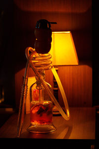 Close-up of illuminated electric lamp on table