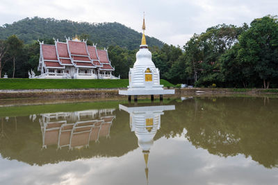 Reflection of building on lake against sky