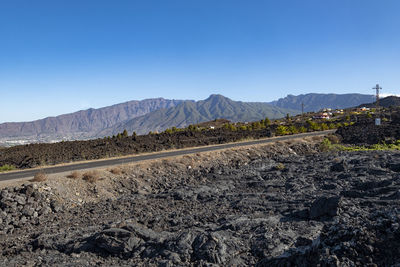 Scenic view of mountains against clear blue sky