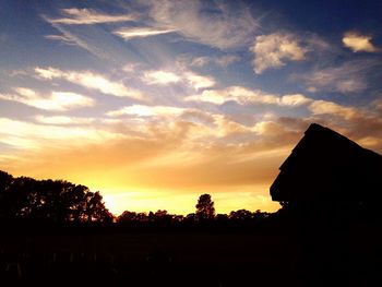 Silhouette of trees against sky at sunset