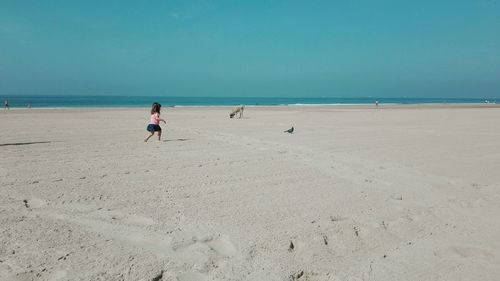 Boy on beach against sky