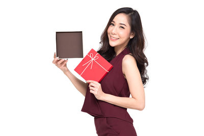 Portrait of a smiling young woman against white background