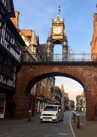 View of arch bridge and buildings against sky