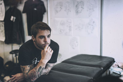 Young man sitting at home