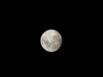 Low angle view of moon against clear sky at night