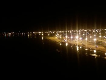 Reflection of illuminated sky on water at night